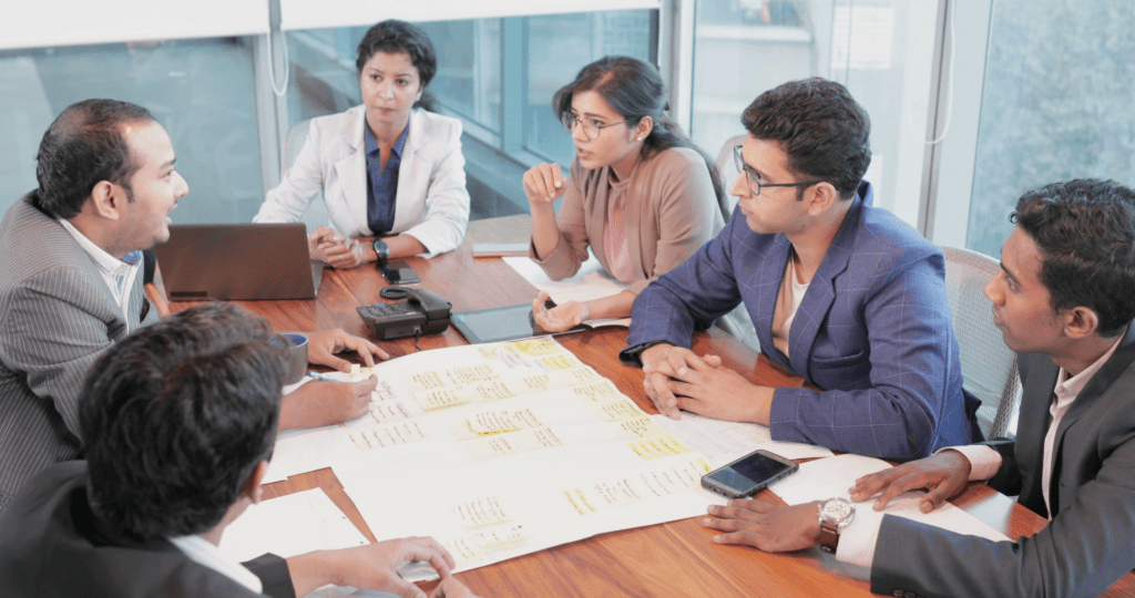 Government officials in discussion meeting reflecting public expectations versus reality on pay commission changes