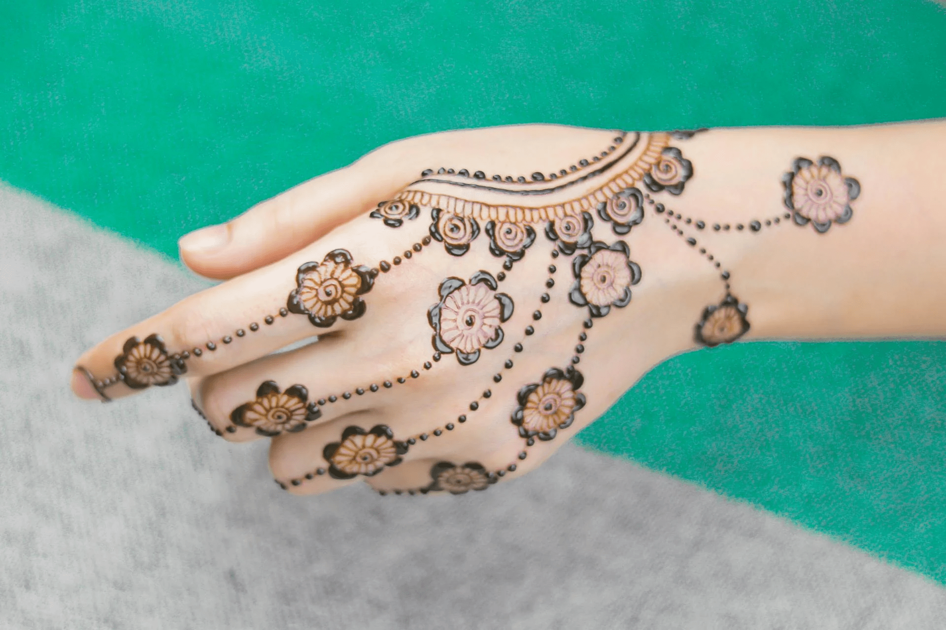 Indian woman showcasing modern Karva Chauth mehndi in soft natural lighting