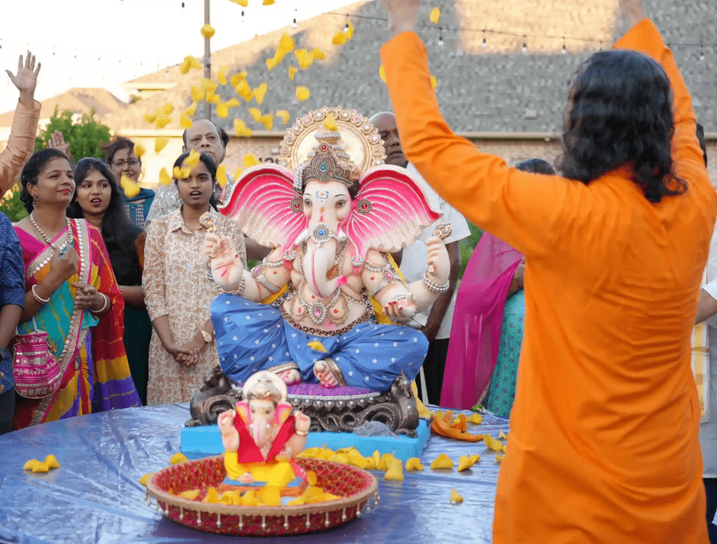 Daily Ganesh puja practice with lamps flowers and focused spiritual rhythm