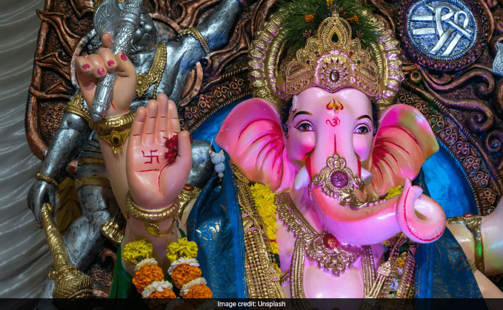 Devotees performing Ganesh Chaturthi puja during the Madhyahna muhurat