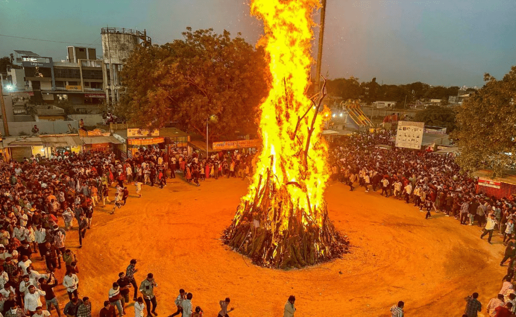 Two phases of Holi showing Holika Dahan fire and daytime color celebrations