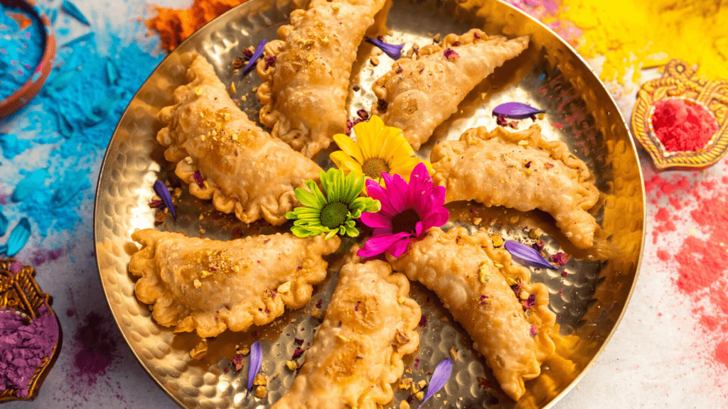 Traditional Holi sweets like gujiya and festive thandai drink